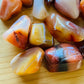 Top view of Grade AA Carnelian tumbled stone, sourced from Boeny, Madagascar
