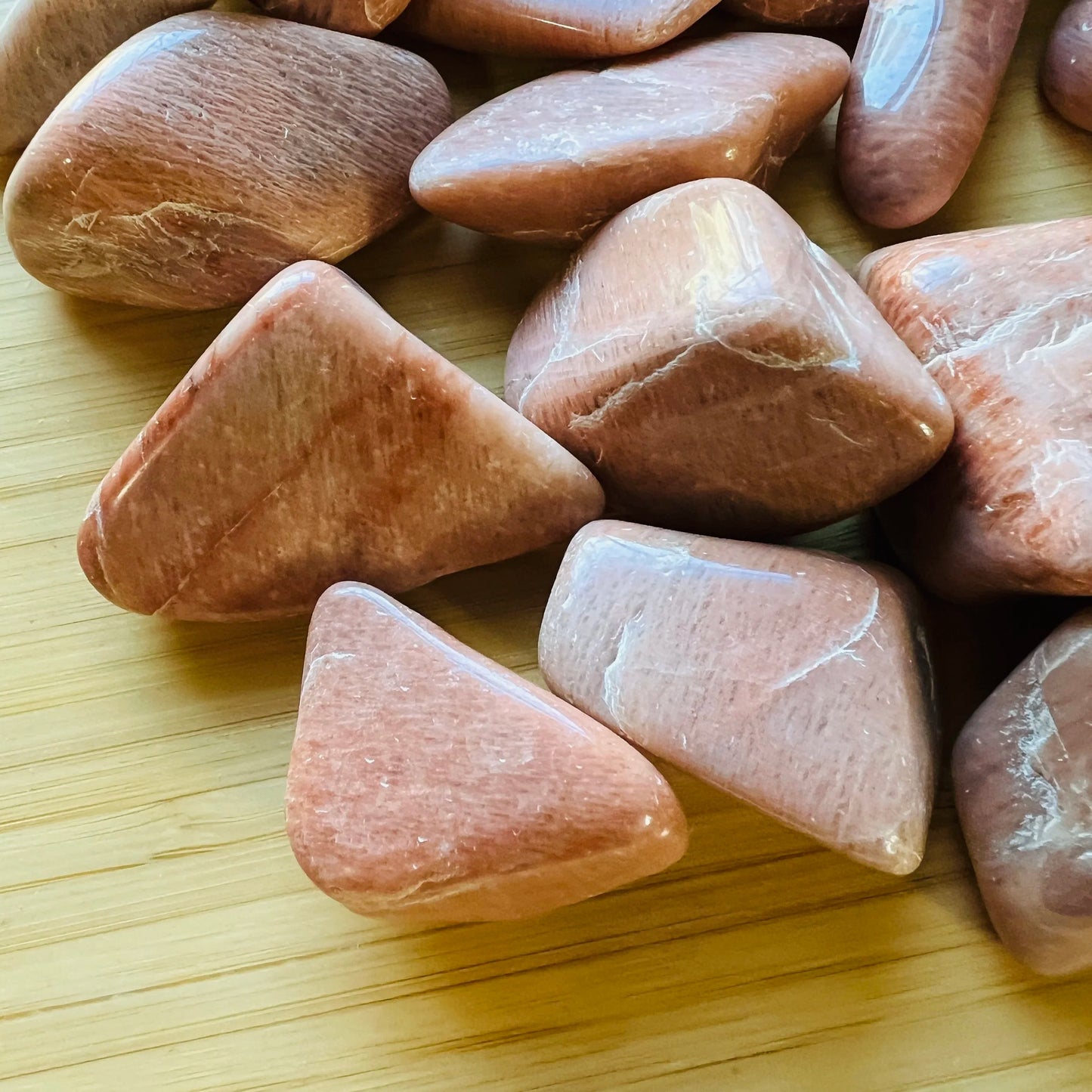 Detail of Peach Moonstone tumbled stone, showing natural variation.
