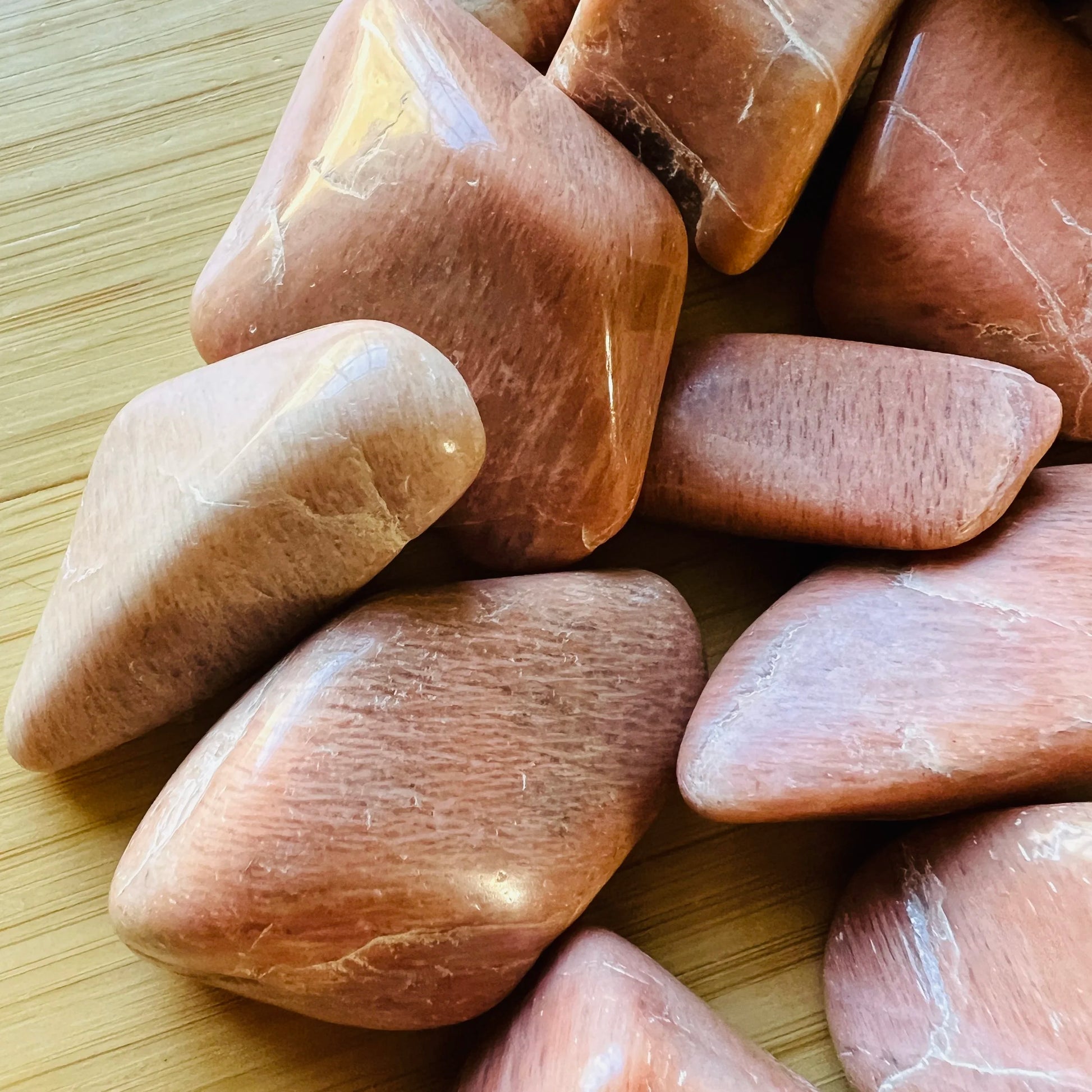 Bird's-eye view of Peach Moonstone tumbled stone, linked to Emotional Healing, sourced from Madagascar.
