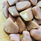 Plan view of Peach Moonstone tumbled stone, from Madagascar, showing natural inclusions.