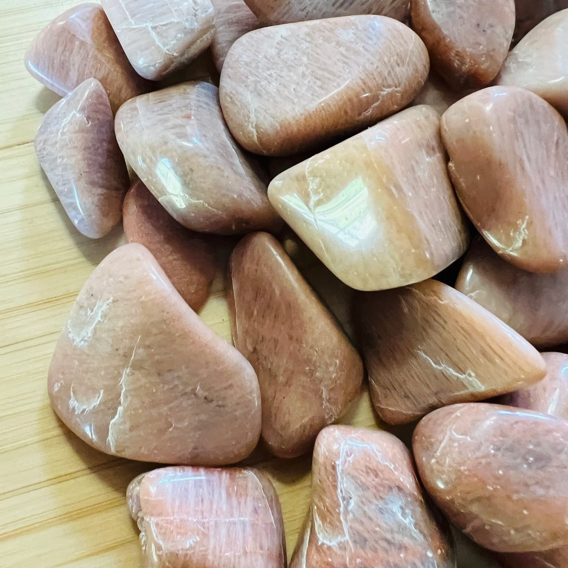 Plan view of Peach Moonstone tumbled stone, from Madagascar, showing natural inclusions.