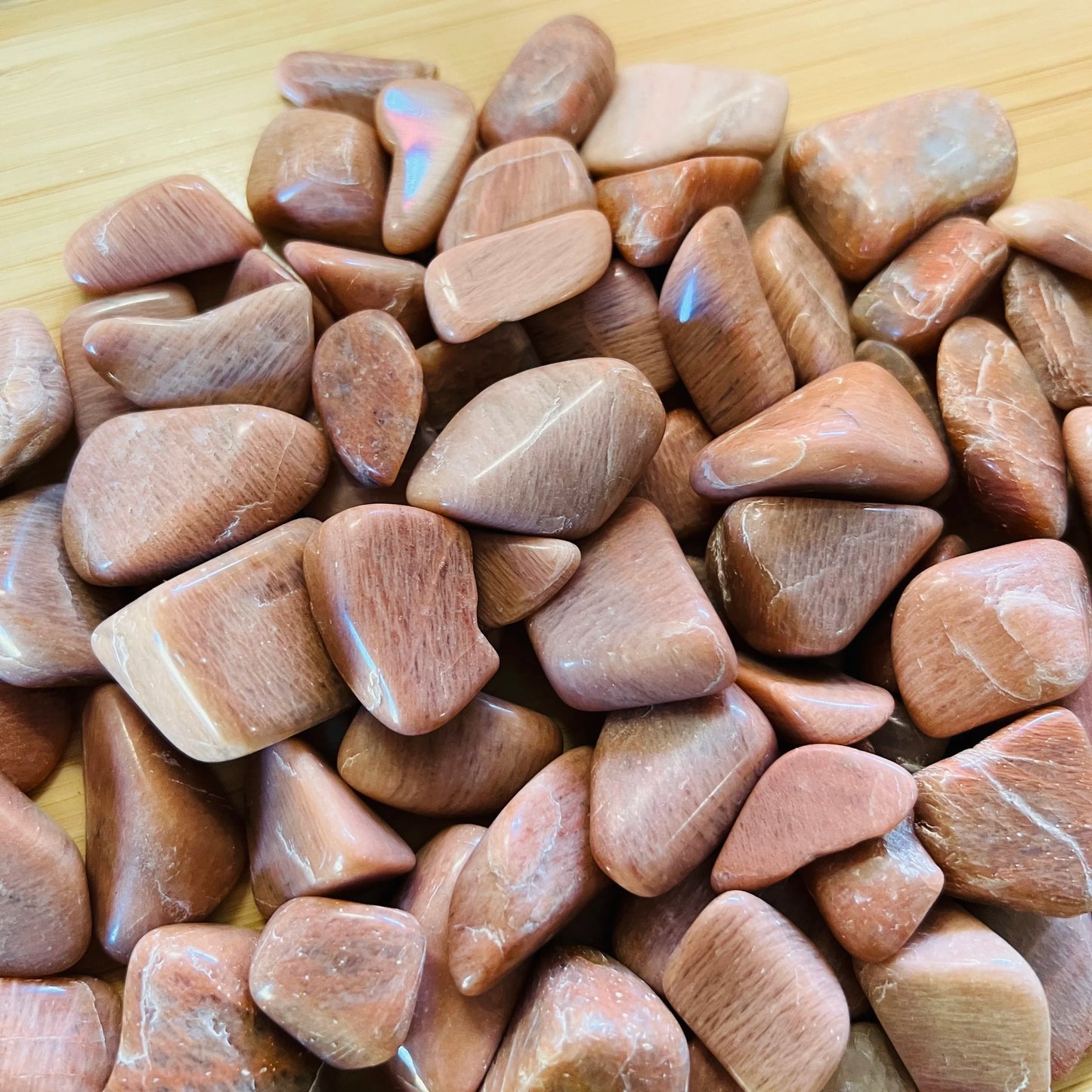 Magnified detail of Peach Moonstone tumbled stone, Madagascar-sourced, turned to for Emotional Healing and Self Love.