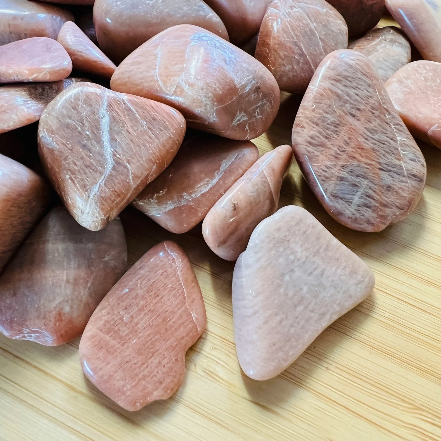 Reverse angle of Peach Moonstone tumbled stone, drawn on for Emotional Healing and Self Love.