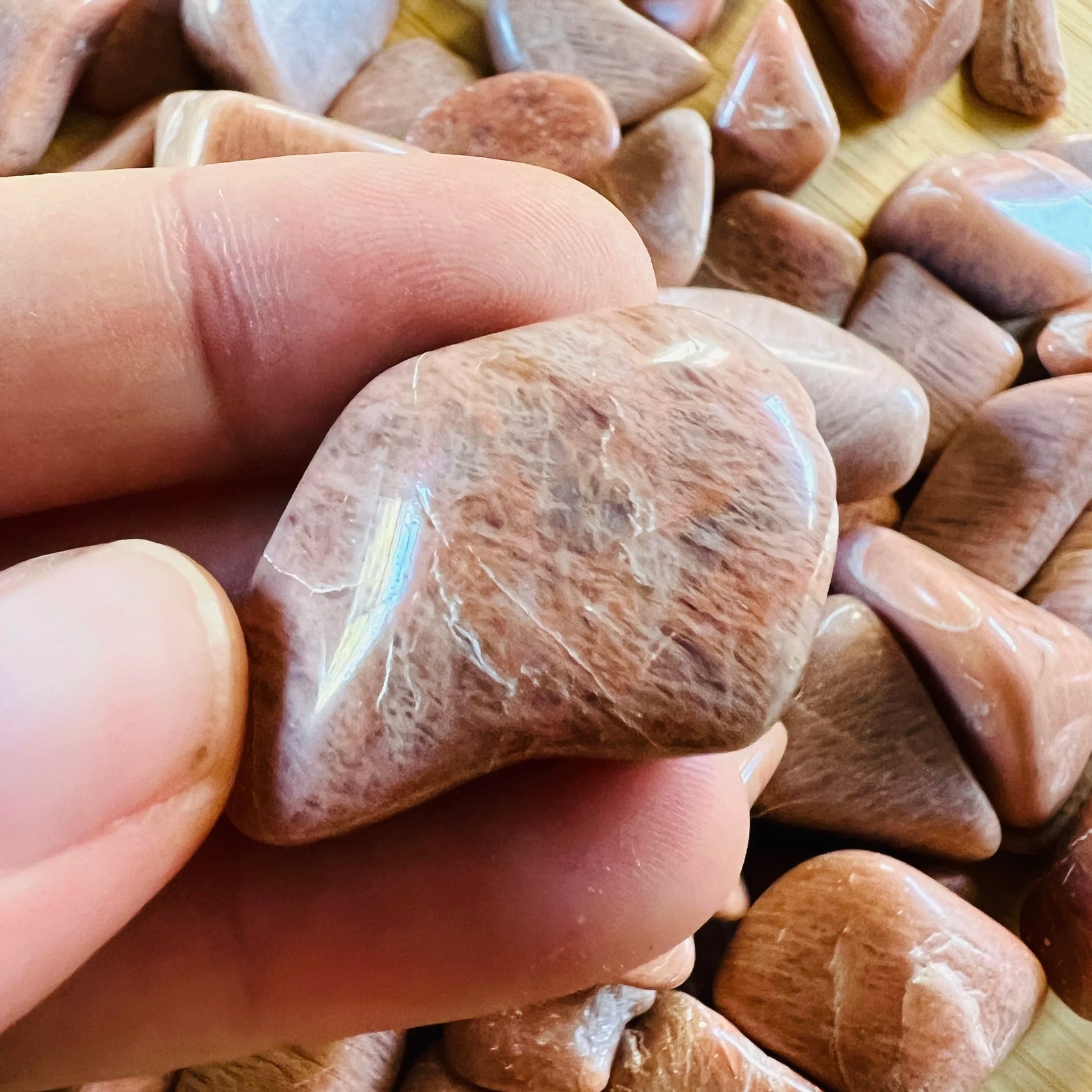 Close-up of Peach Moonstone tumbled stone from Madagascar, soothing wellness stone for Emotional Healing
