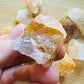 Display context of Golden Healer raw crystal, shown alongside the hand for scale.