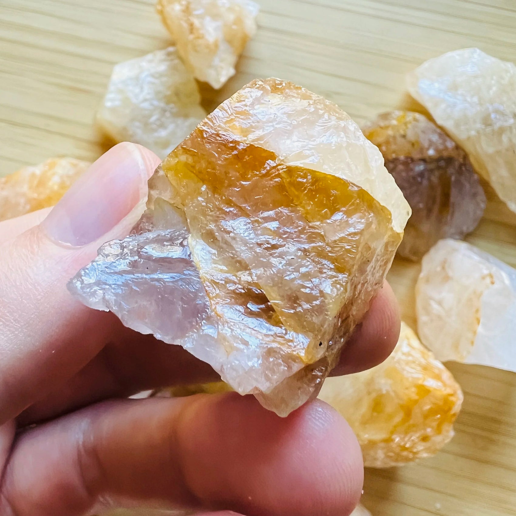 Display context of Golden Healer raw crystal, shown alongside the hand for scale.