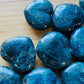 Sideways view of Apatite polished heart, Madagascar-sourced, associated with Focus.