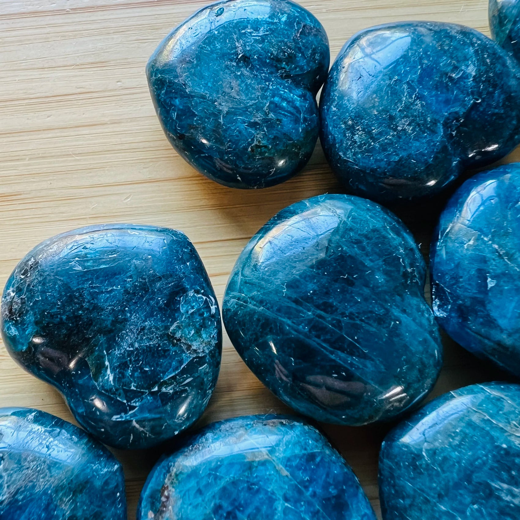 Sideways view of Apatite polished heart, Madagascar-sourced, associated with Focus.