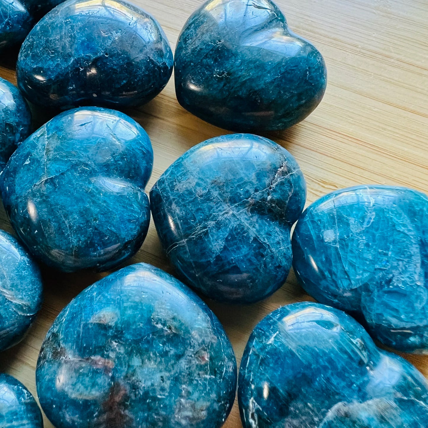 Back view of Apatite polished heart, hand-selected from Anosy, Madagascar, traditionally used for Focus.