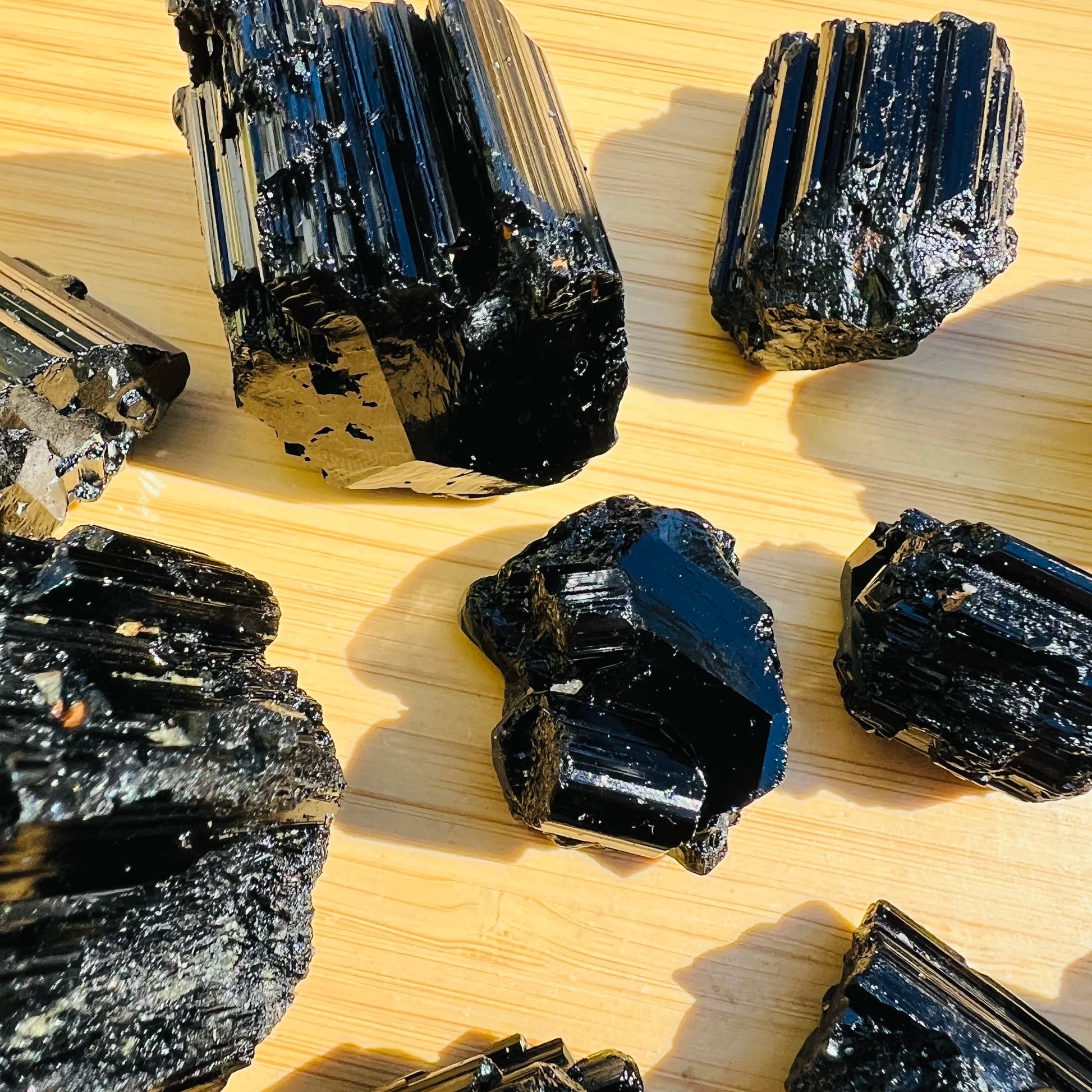 Grade aaa black tourmaline raw held in hand for size reference