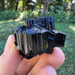 Sideways view of Black Tourmaline raw stone, Madagascar-sourced.