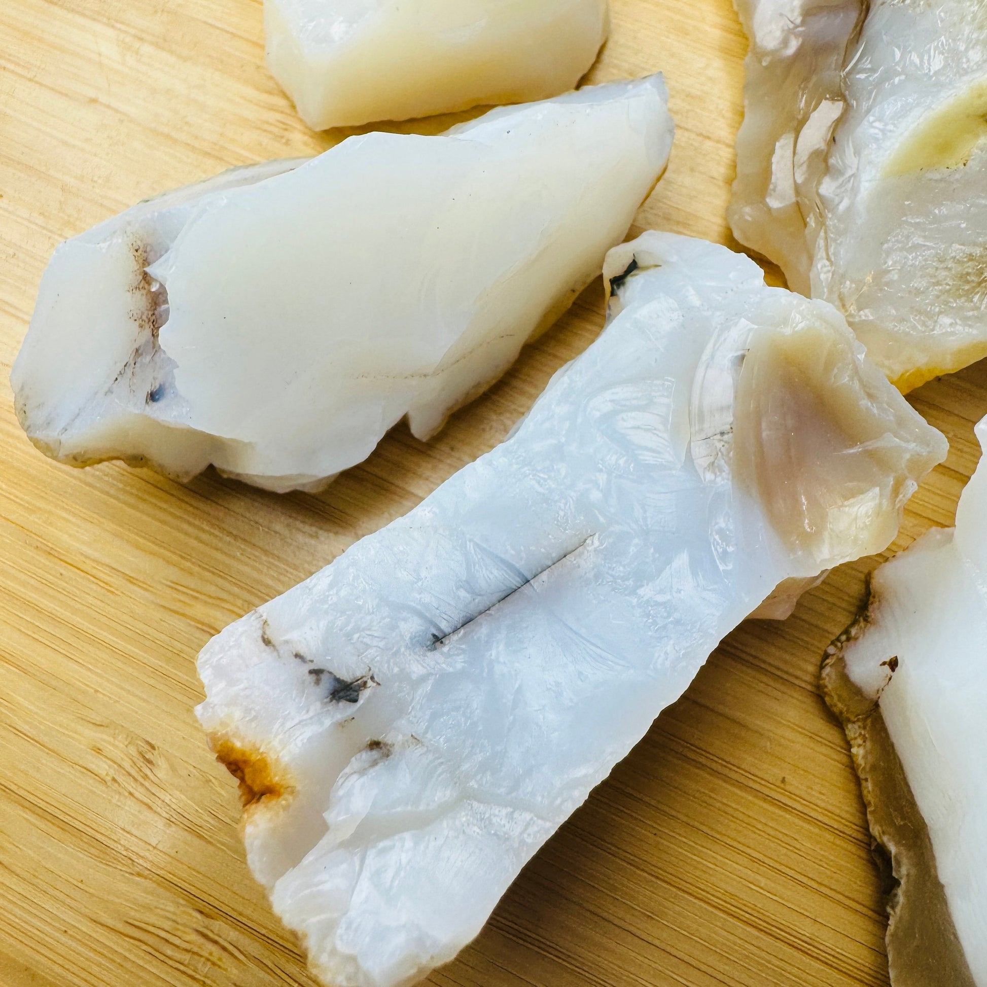 Top-side view of White Opal raw stone, showing tight grain.