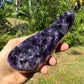 Grade aaa amethyst geode held in hand for size reference