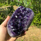 Grade aaa amethyst geode held in hand for size reference