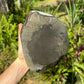 Grade aaa amethyst geode held in hand for size reference