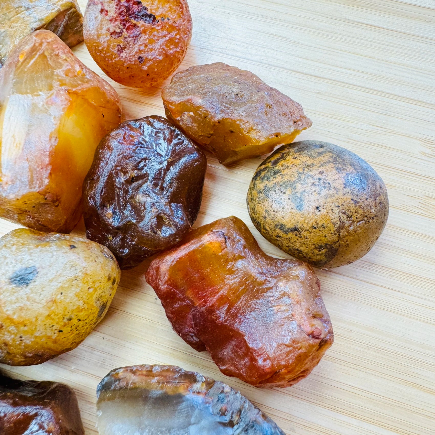 Hand-scale shot of a Carnelian raw stone, sourced from Brazil.