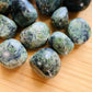 Overhead view of Jade tumbled stone, showing characteristic color.