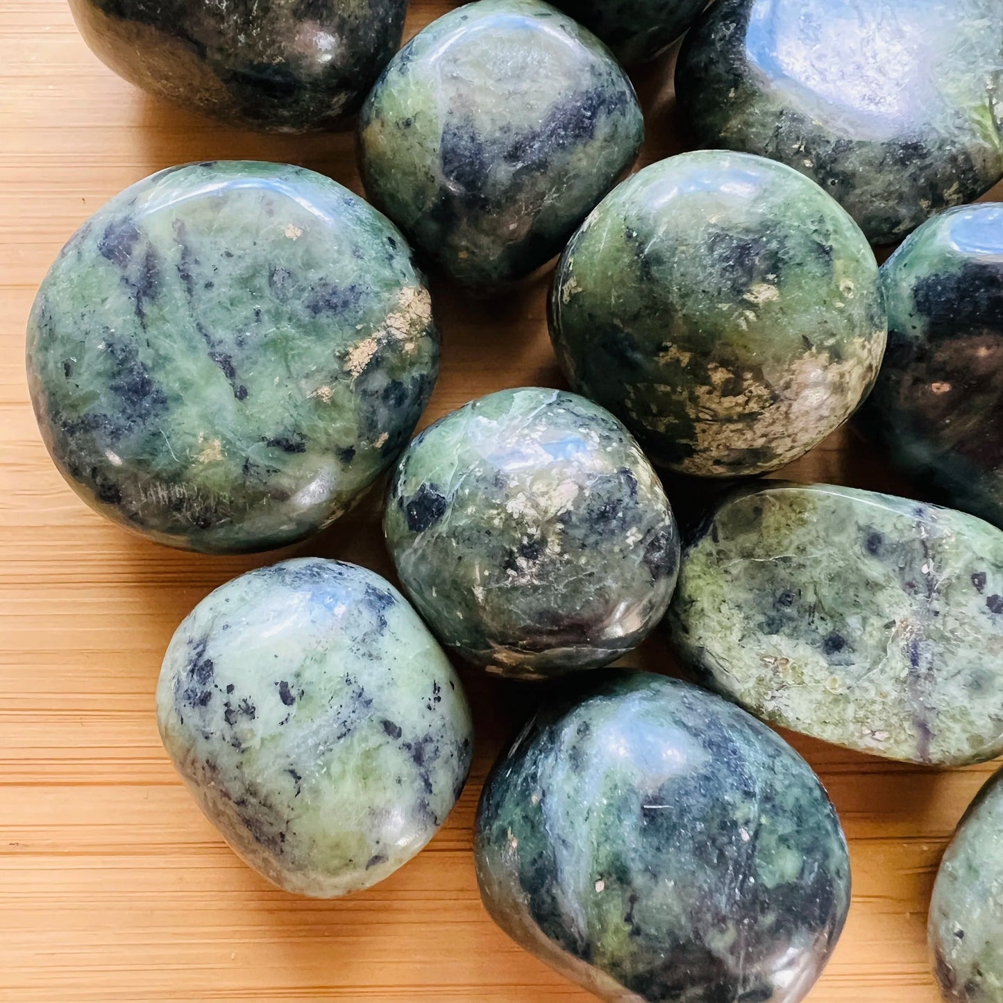 Sideways view of Jade tumbled stone, Peru-sourced.