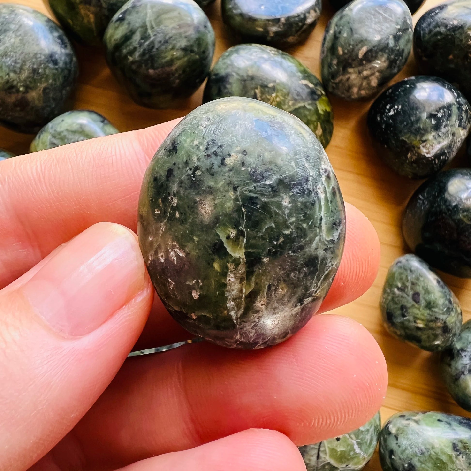 Back view of Grade A Jade tumbled stone showing natural surface