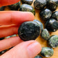 Detail shot of Grade A Jade tumbled stone under natural light