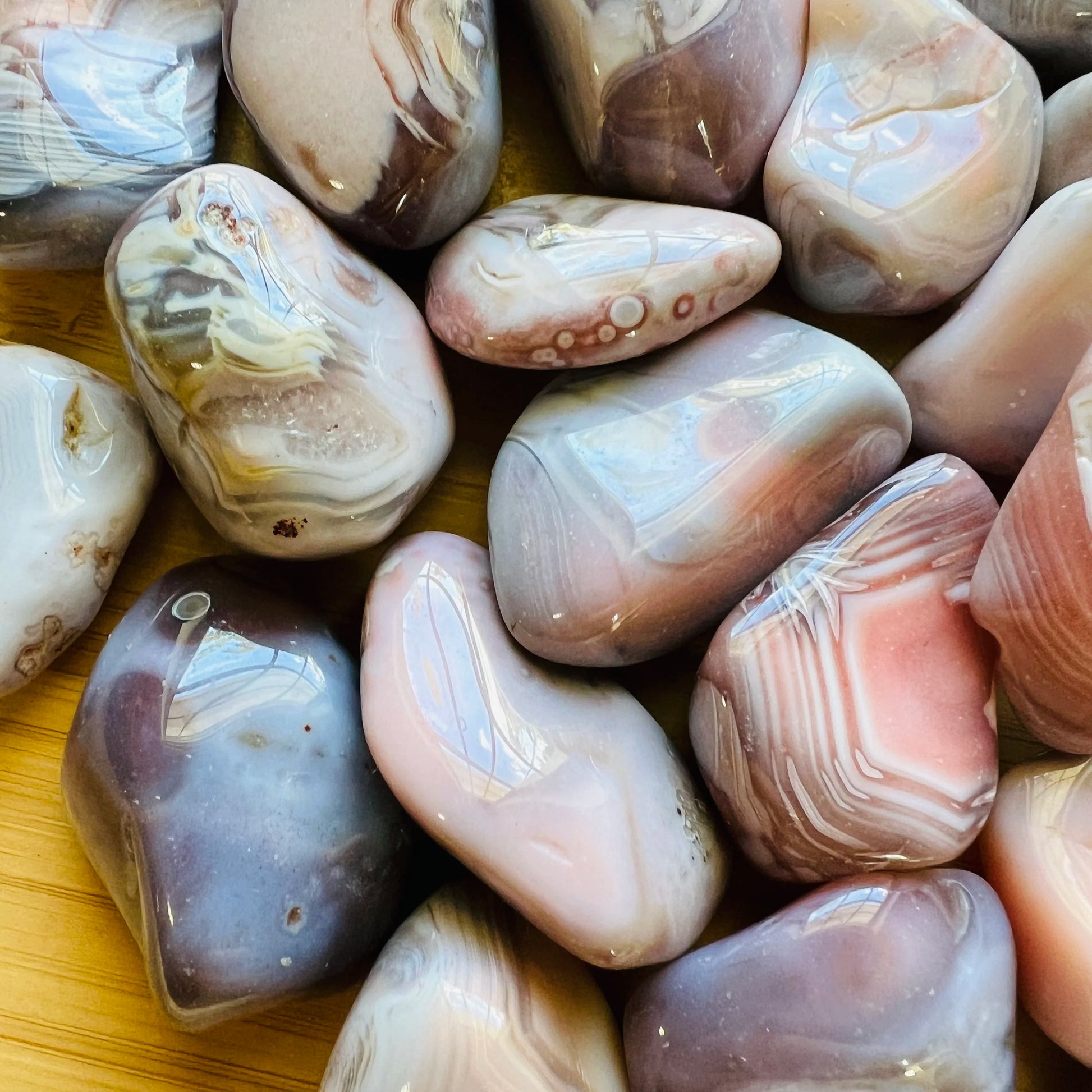 Close-up of Pink Agate tumbled stone, showing soft luster.