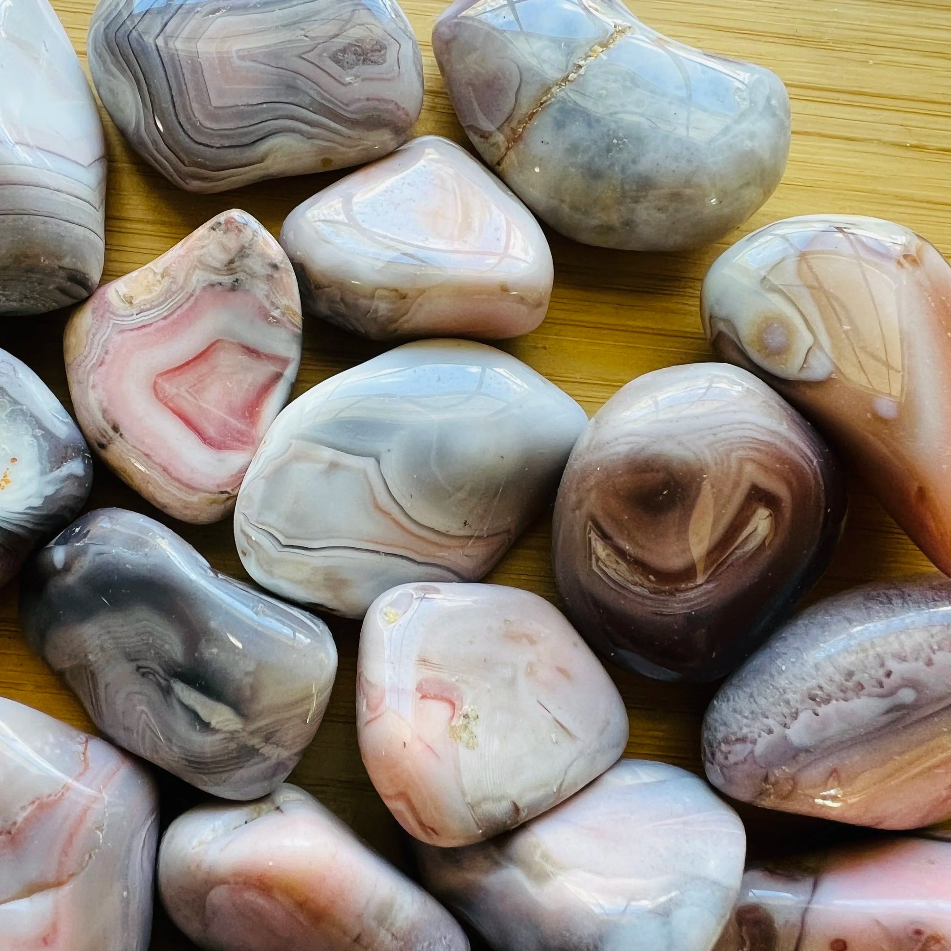 Bird's-eye view of Pink Agate tumbled stone, sourced from Botswana, often worked with for Love.