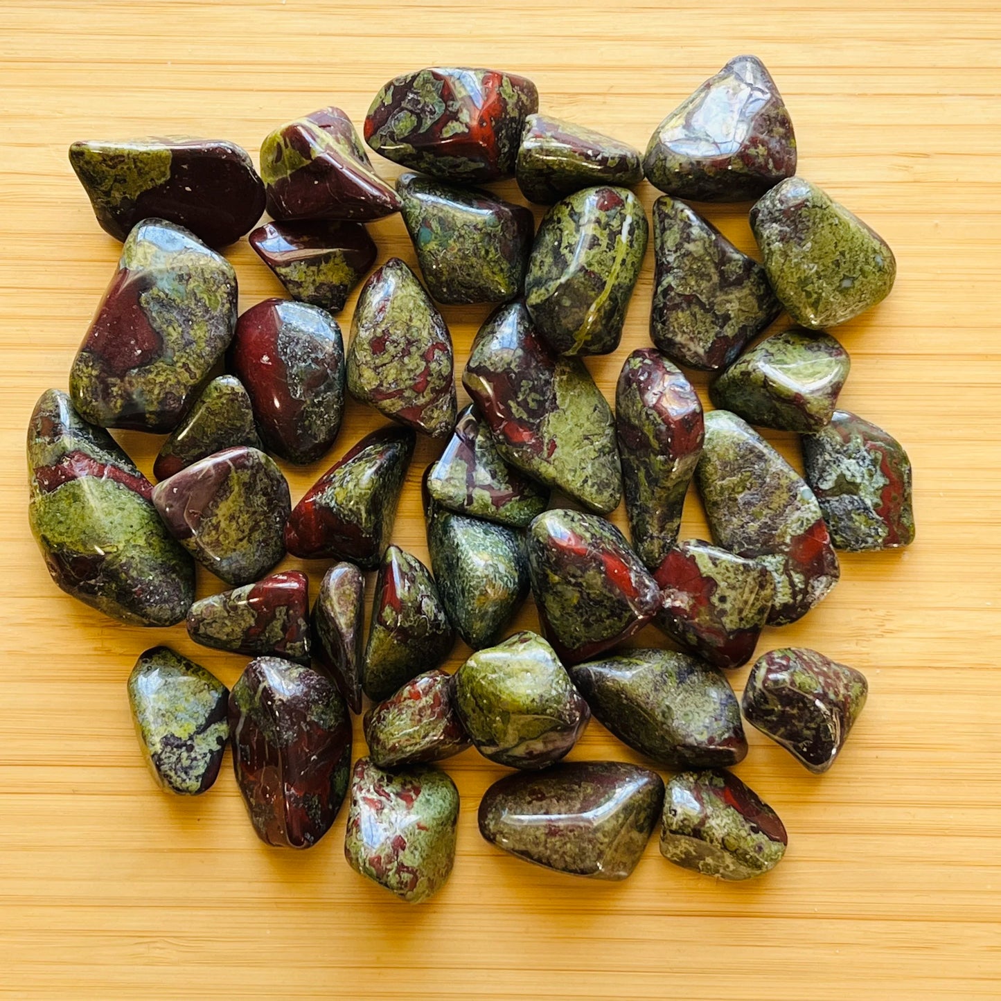 Back view of Grade AA Dragon Bloodstone tumbled stone showing natural surface