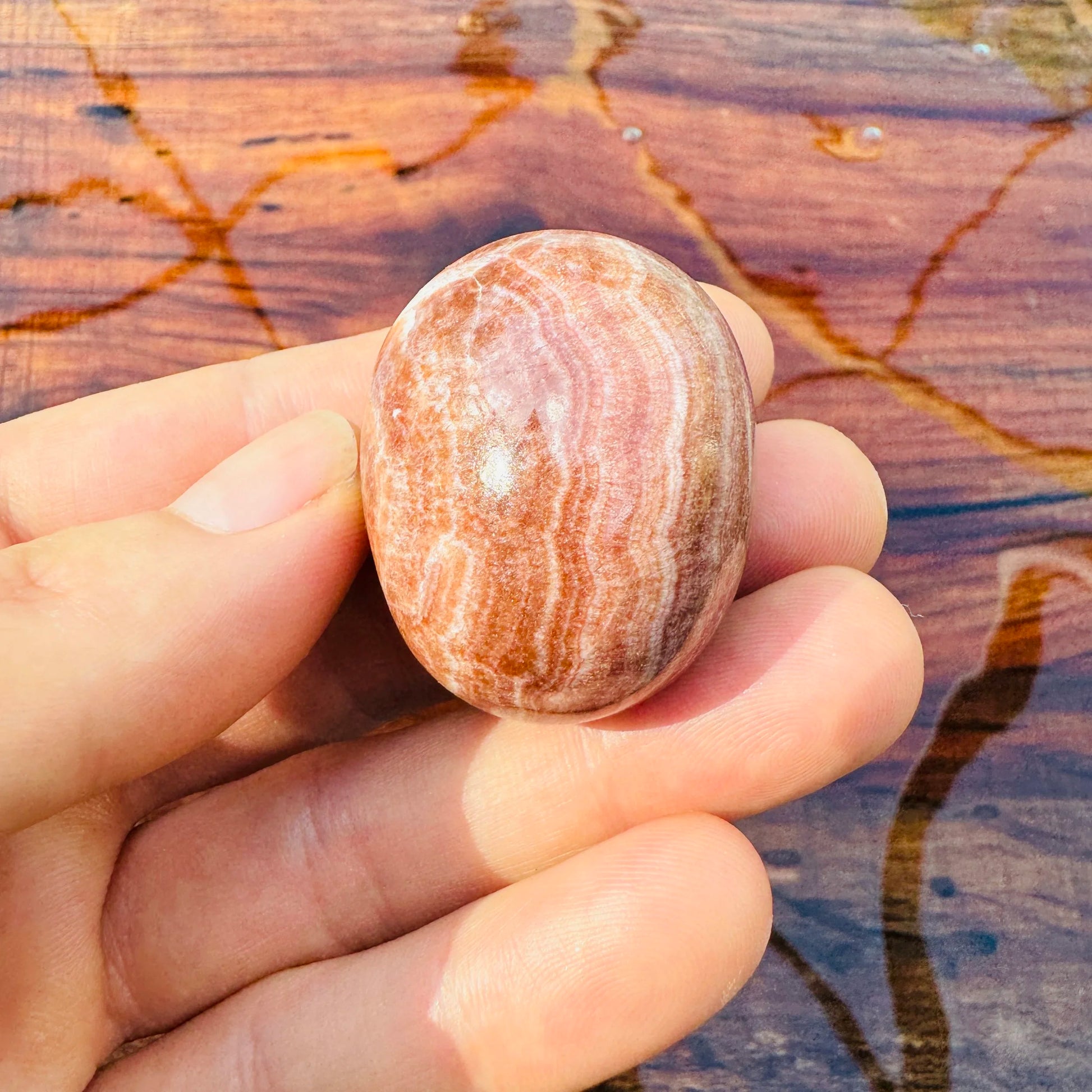 Full profile of Grade AAA Red Aragonite tumbled stone ready to ship from Beyond Bohemian