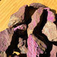 Alternate angle of Purpurite raw stone, showing natural patina.