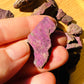 Detail shot of Grade A Purpurite raw under natural light