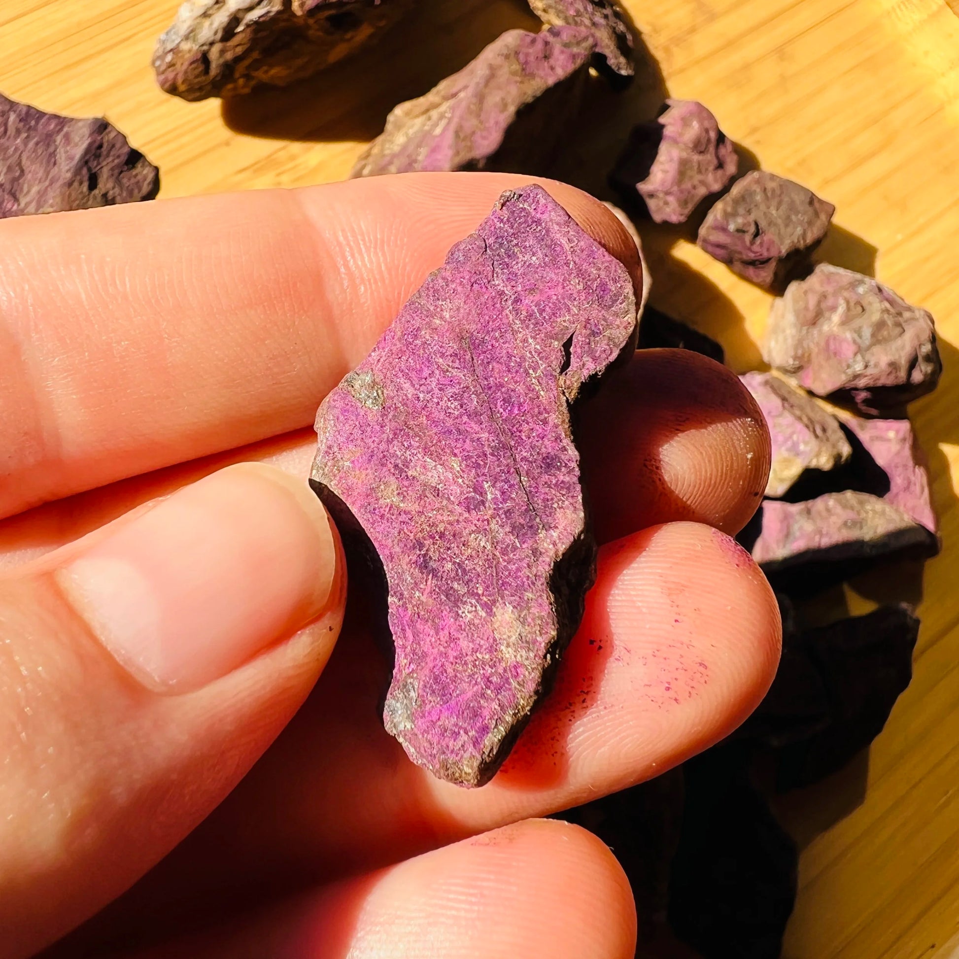 Detail shot of Grade A Purpurite raw under natural light
