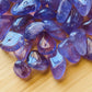 Macro view of Amethyst tumbled stone, worked with for Stress Relief, showing subtle veining.