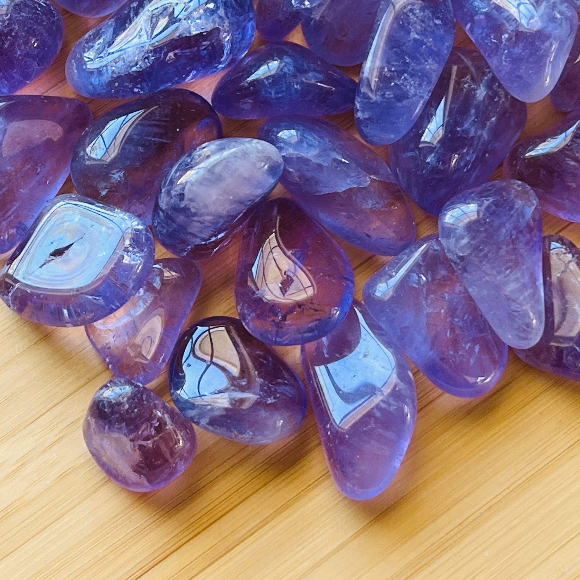 Macro view of Amethyst tumbled stone, worked with for Stress Relief, showing subtle veining.