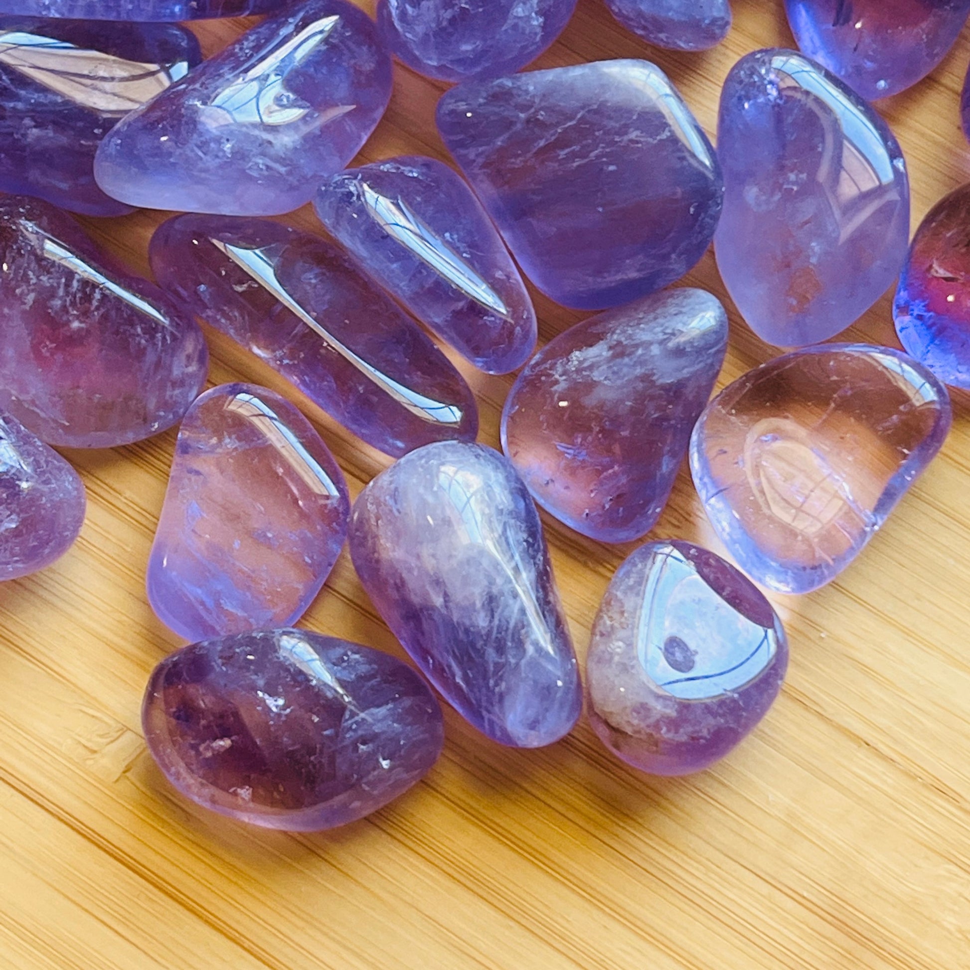 Edge-on view of Amethyst tumbled stone, hand-selected from Rio Grande do Sul, Brazil, kept near for Stress Relief.