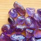 Plan view of Amethyst tumbled stone, showing translucent edges.