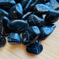Side perspective of Grade AA Black Tourmaline tumbled stone, carried for Protection and Grounding.