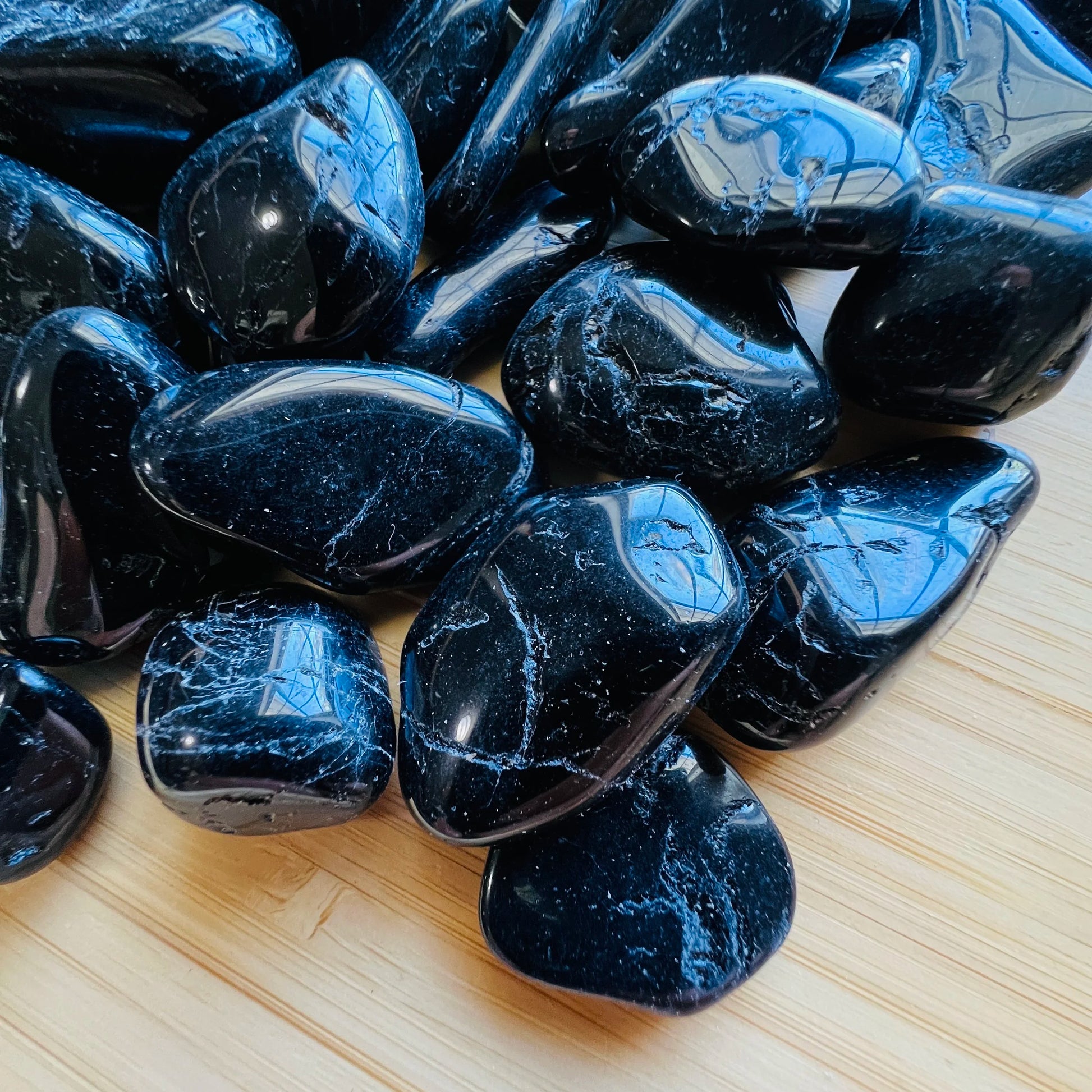 Side perspective of Grade AA Black Tourmaline tumbled stone, carried for Protection and Grounding.