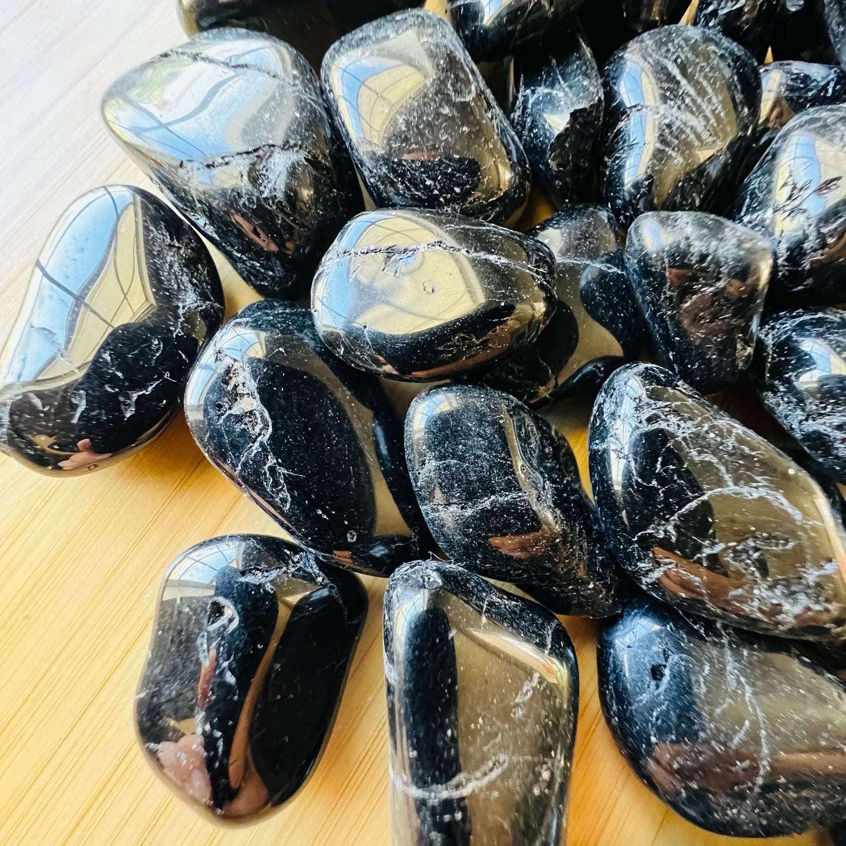 Close-up of Black Tourmaline tumbled stone from Brazil, soothing wellness stone for Stress Relief