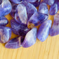 Lateral view of Amethyst tumbled stone, drawn on for Stress Relief.
