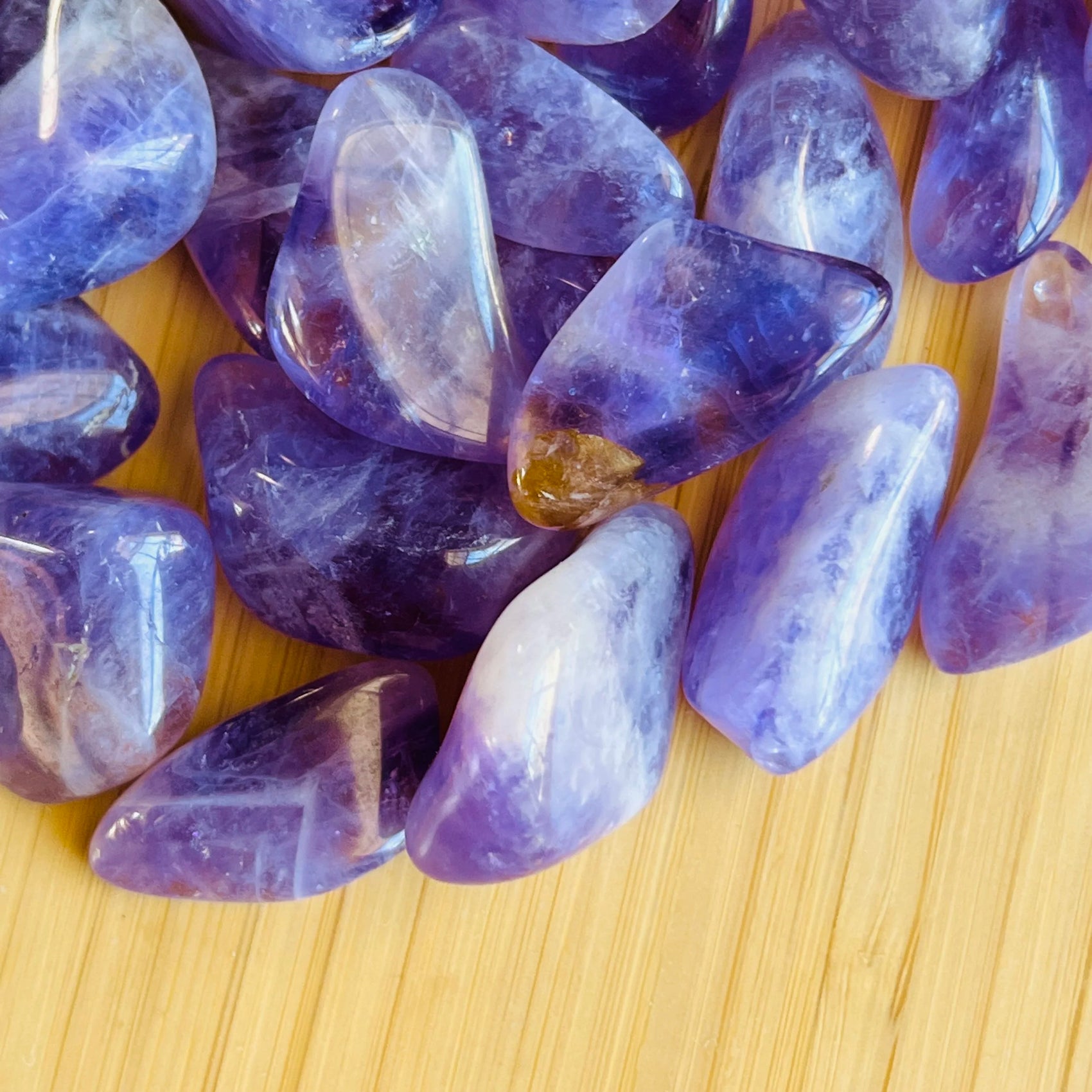 Lateral view of Amethyst tumbled stone, drawn on for Stress Relief.