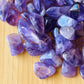 Rear view of Amethyst tumbled stone, hand-selected from Analamanga, Madagascar, showing earthy tone.