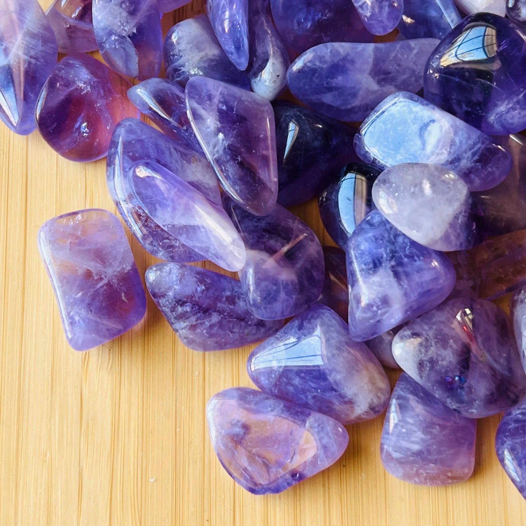 Rear view of Amethyst tumbled stone, hand-selected from Analamanga, Madagascar, showing earthy tone.