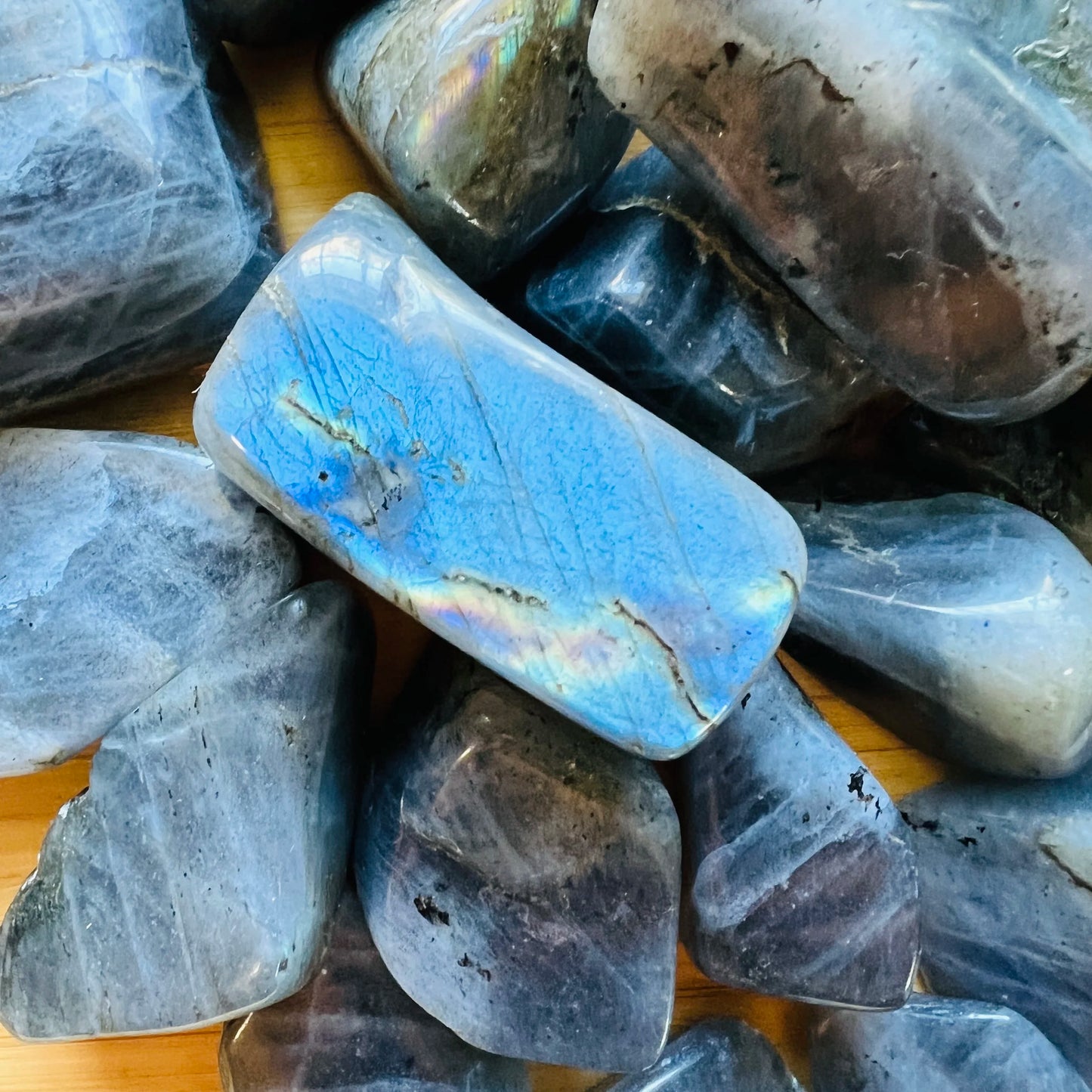 Top angle of Grade AA gray Labradorite tumbled stone, from Madagascar.
