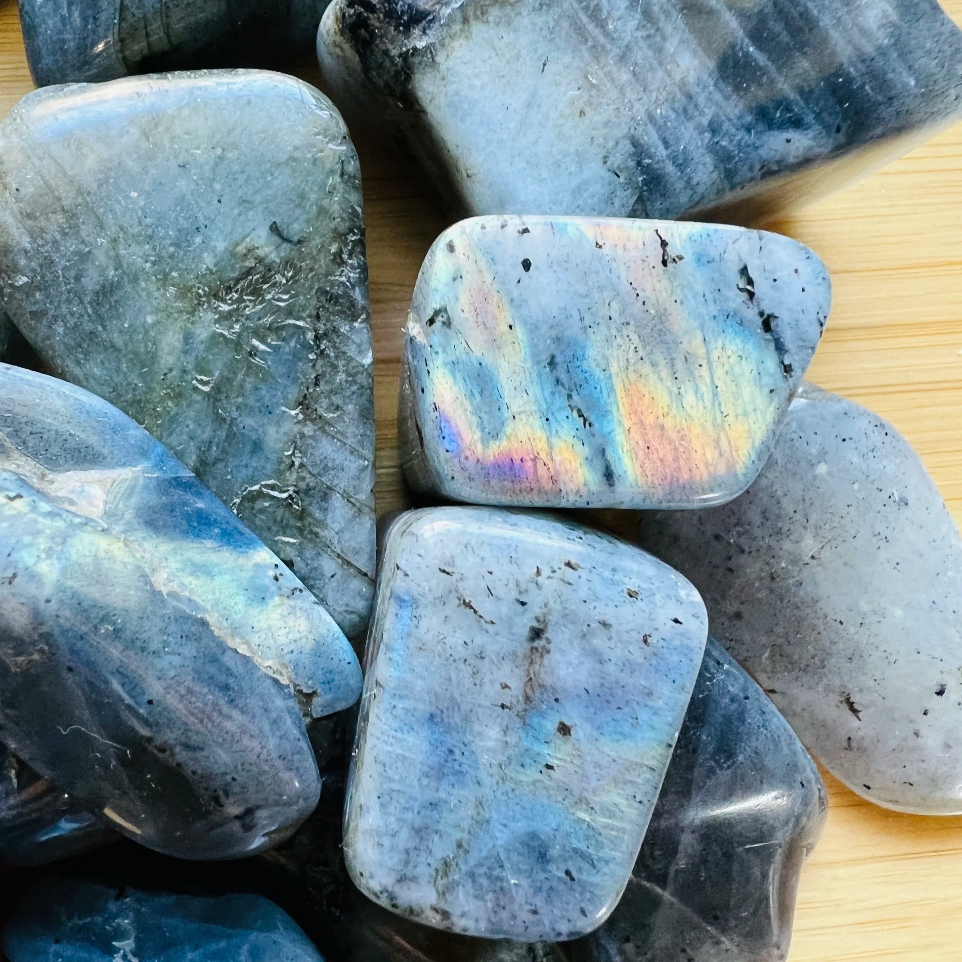 Macro view of Grade AA gray Labradorite tumbled stone, showing soft luster, hand-selected from Atsimo-Andrefana, Madagascar.