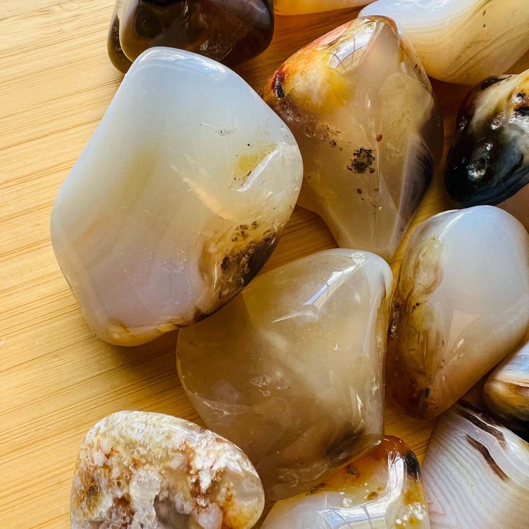 Plan view of Dendritic Agate tumbled stone, showing earthy tone, turned to for Grounding.