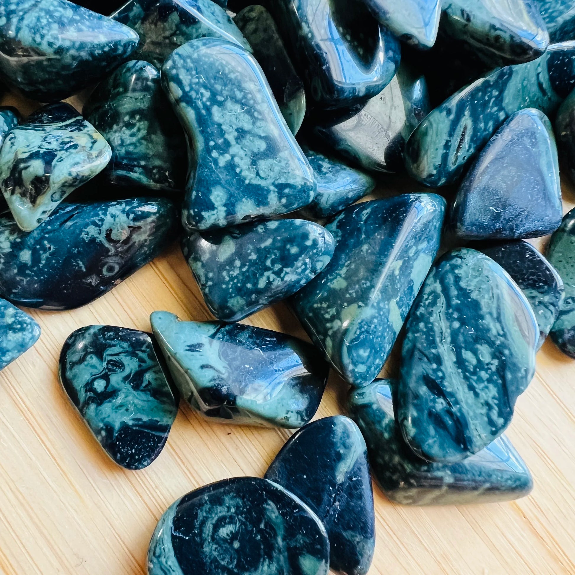 Lateral view of green Kambaba Jasper tumbled stone, for Grounding.