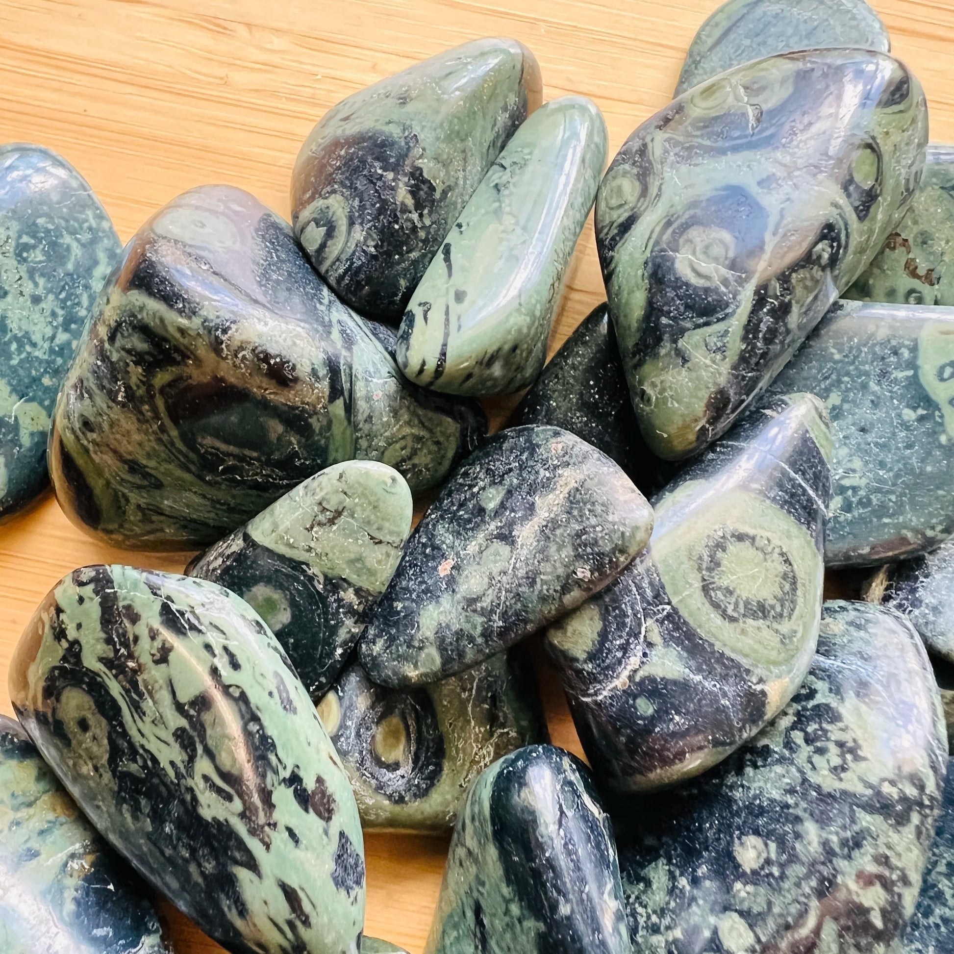 Up-close view of Kambaba Jasper tumbled stone, showing subtle veining.