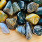 Overhead angle of Grade A green Ocean Jasper tumbled stone, showing soft luster, worked with for Emotional Healing.