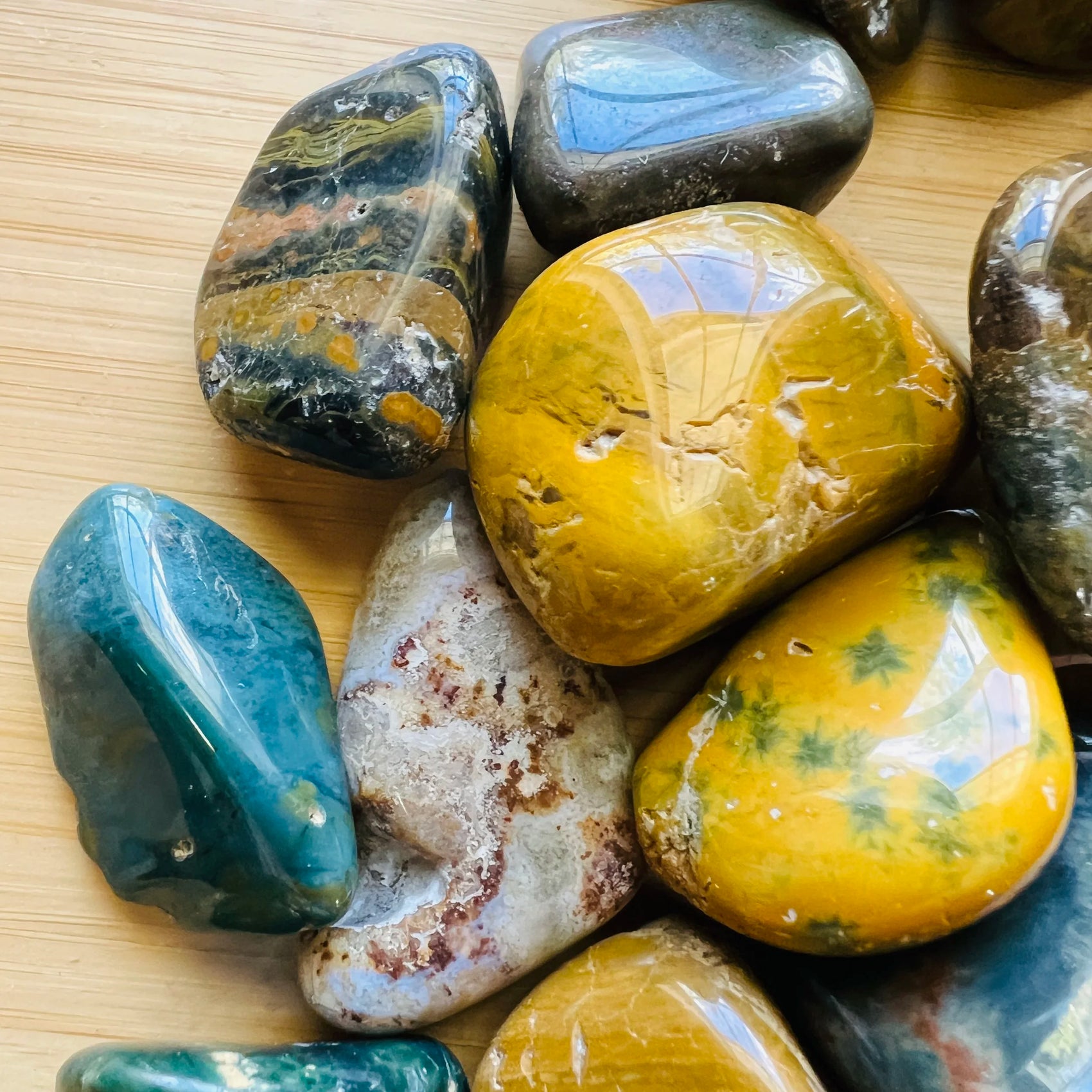 Lateral view of Ocean Jasper tumbled stone, sourced from Madagascar, showing earthy tone.