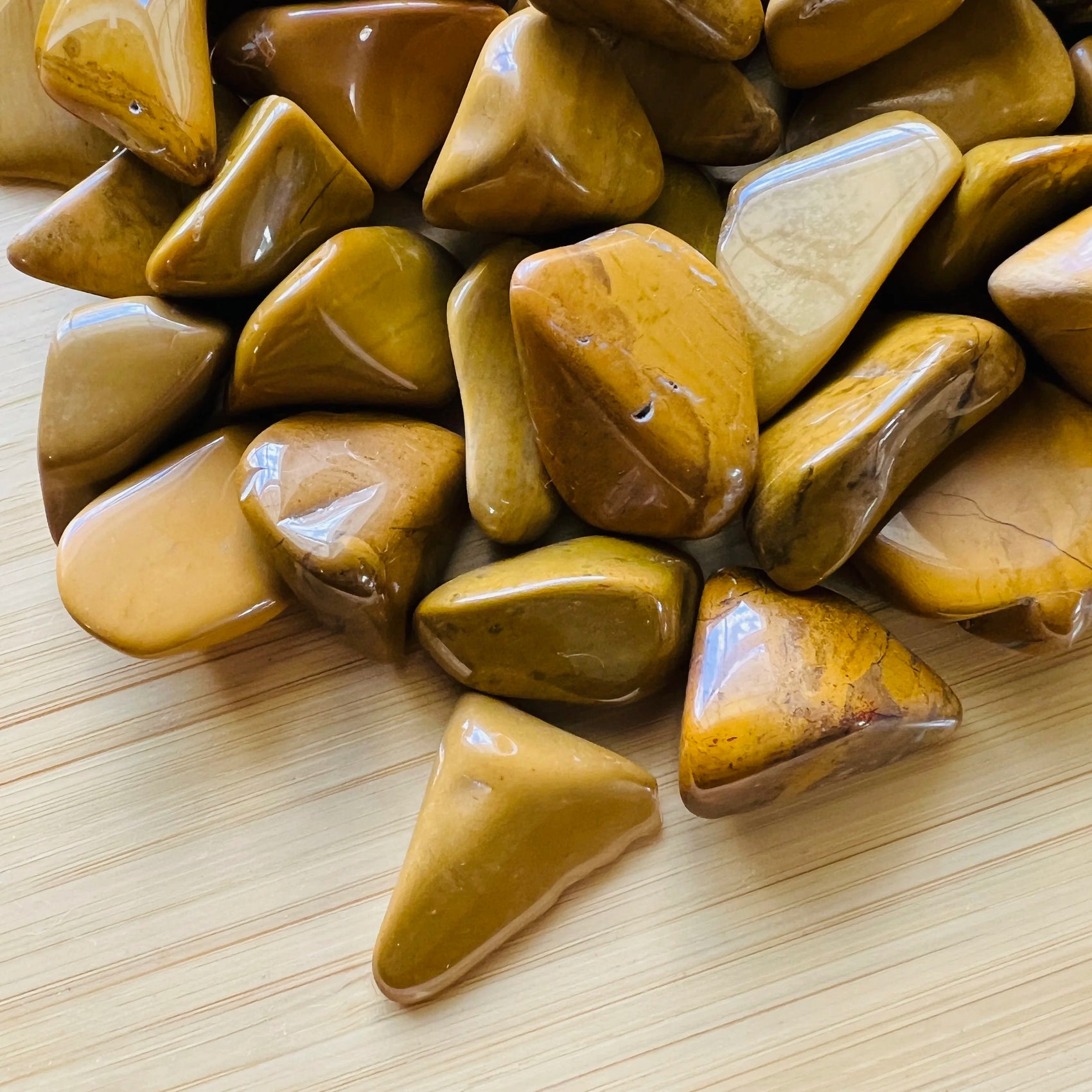 Magnified detail of Yellow Jasper tumbled stone, Madagascar-sourced, often paired with practices around Confidence.